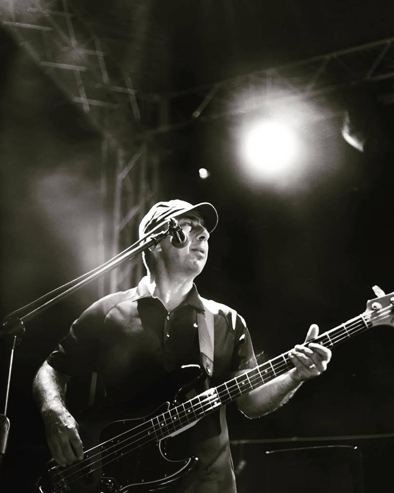 Osman playing bass at festival
